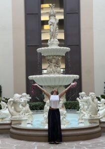 Evangeline Hemrick in front of Fountain with outstreached arms